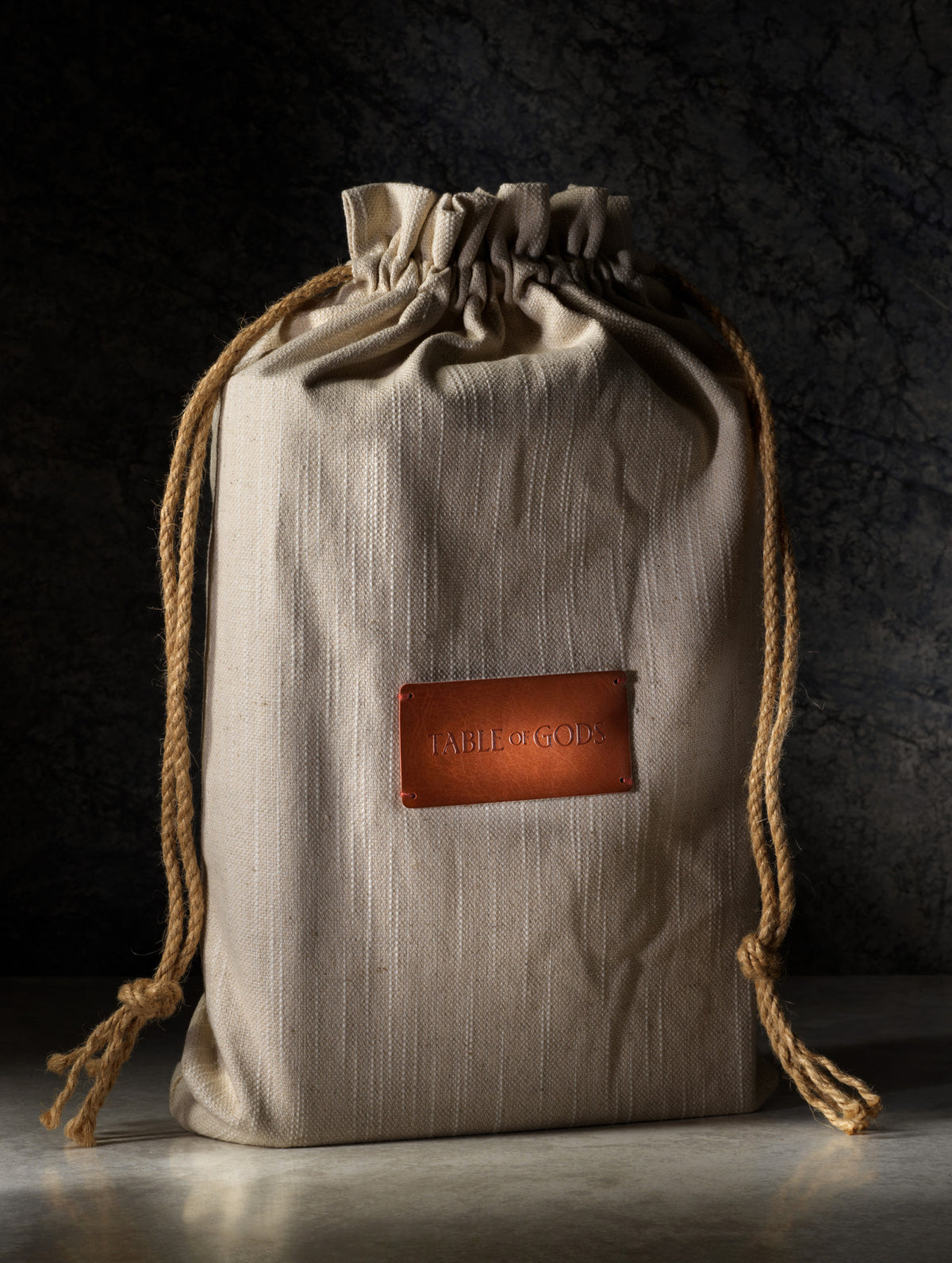 Table of Gods packaged in a drawstring pouch