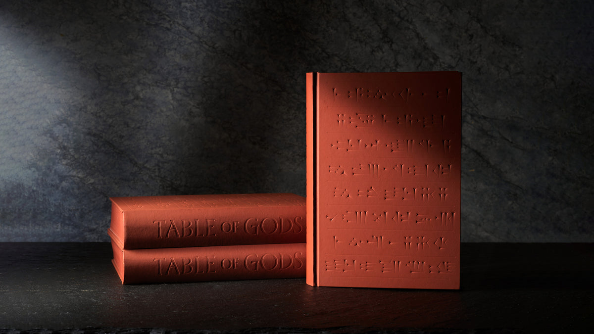 Table of Gods book standing on a dark table